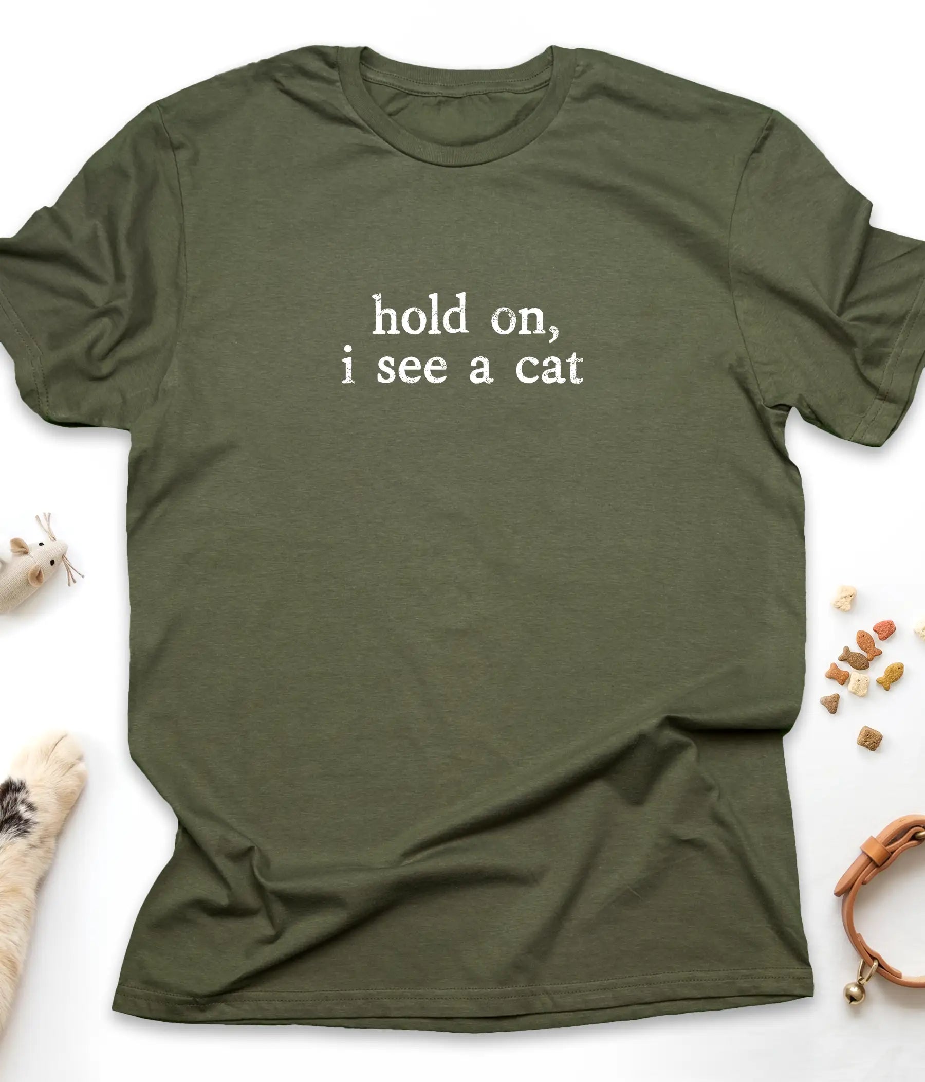Military Green funny cat t-shirt with "Hold On, I See A Cat" design, flat lay top view