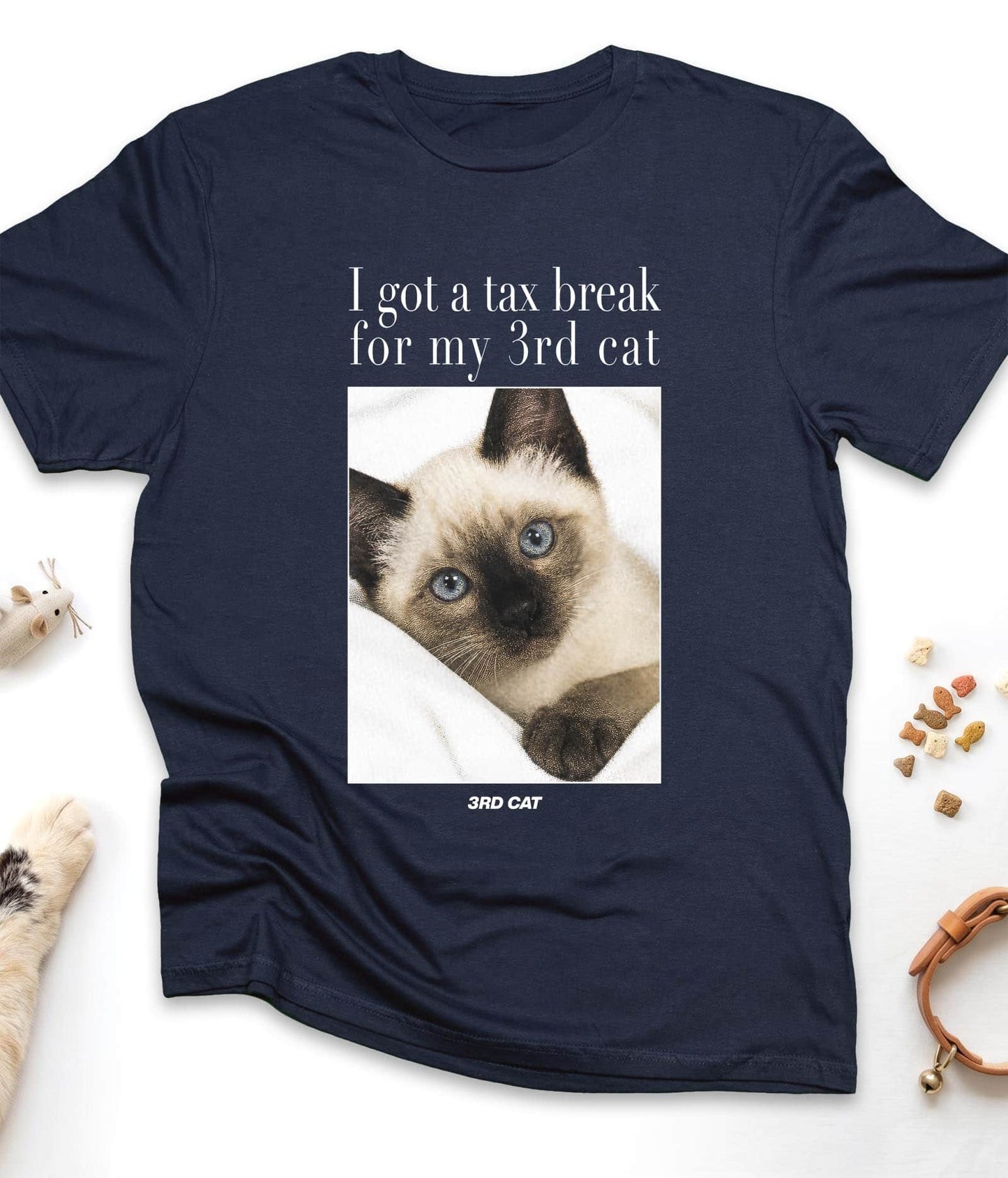 Navy funny cat t-shirt with "I Got A Tax Break For My 3rd Cat (Siamese)" design, flat lay top view