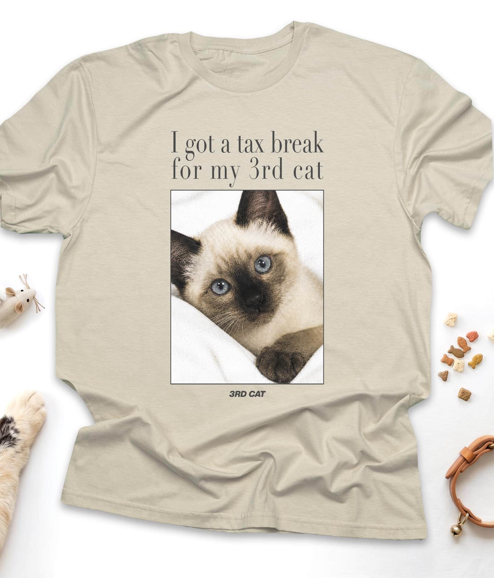 Sand funny cat t-shirt with "I Got A Tax Break For My 3rd Cat (Siamese)" design, flat lay top view