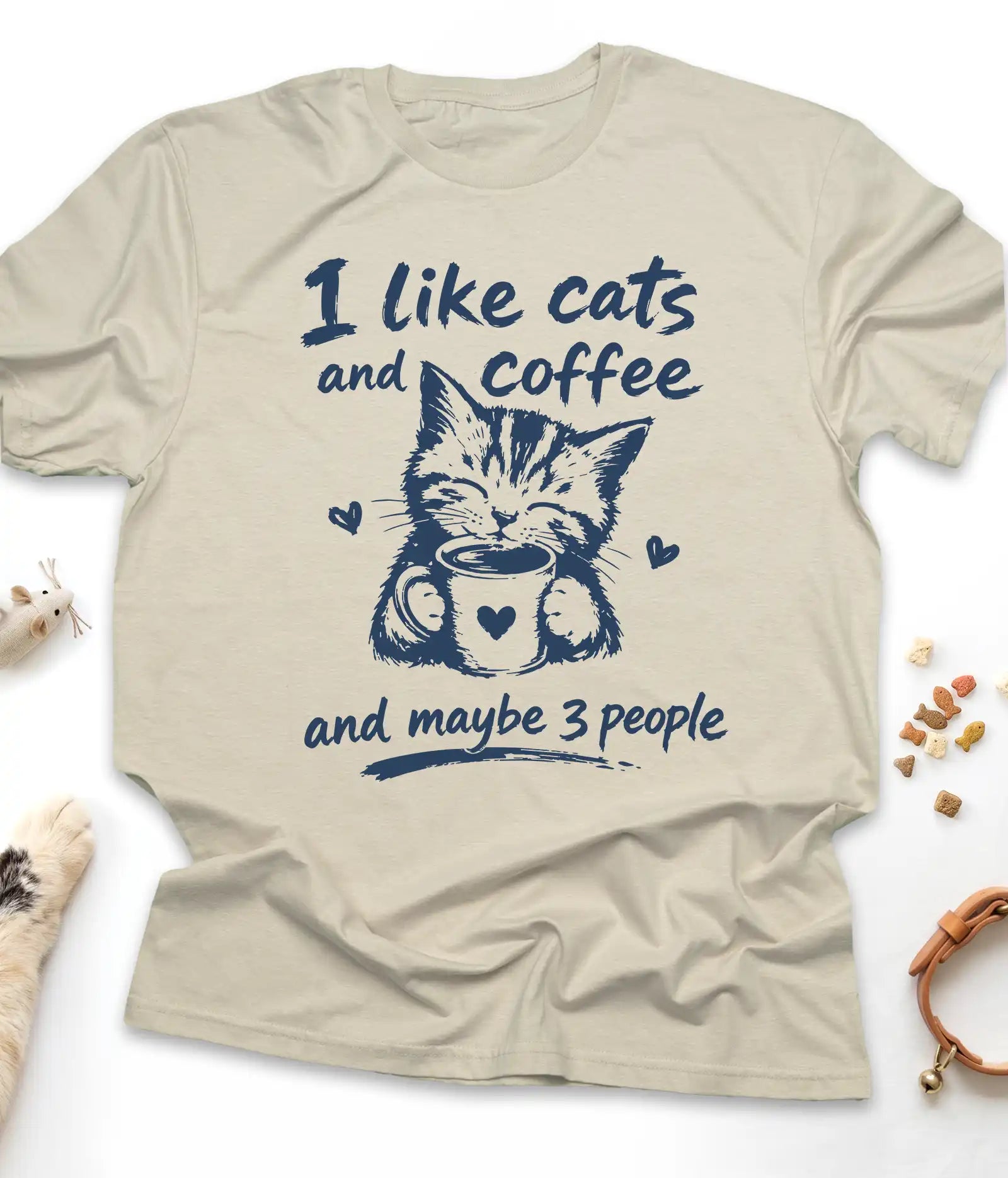 Sand funny cat t-shirt with "I Like Cats And Coffee And Maybe 3 People" design, flat lay top view