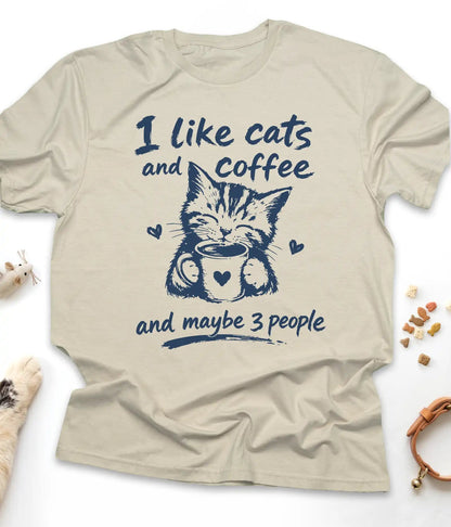 Sand funny cat t-shirt with "I Like Cats And Coffee And Maybe 3 People" design, flat lay top view