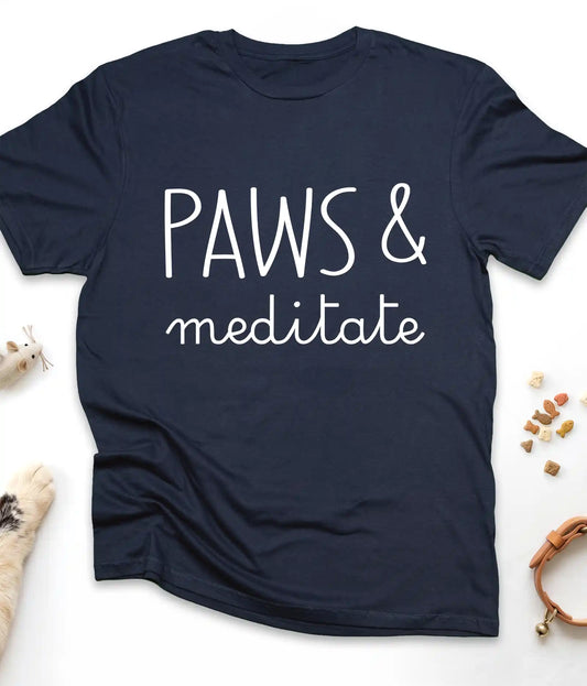 Navy funny cat t-shirt with "Paws & Meditate" design, flat lay top view