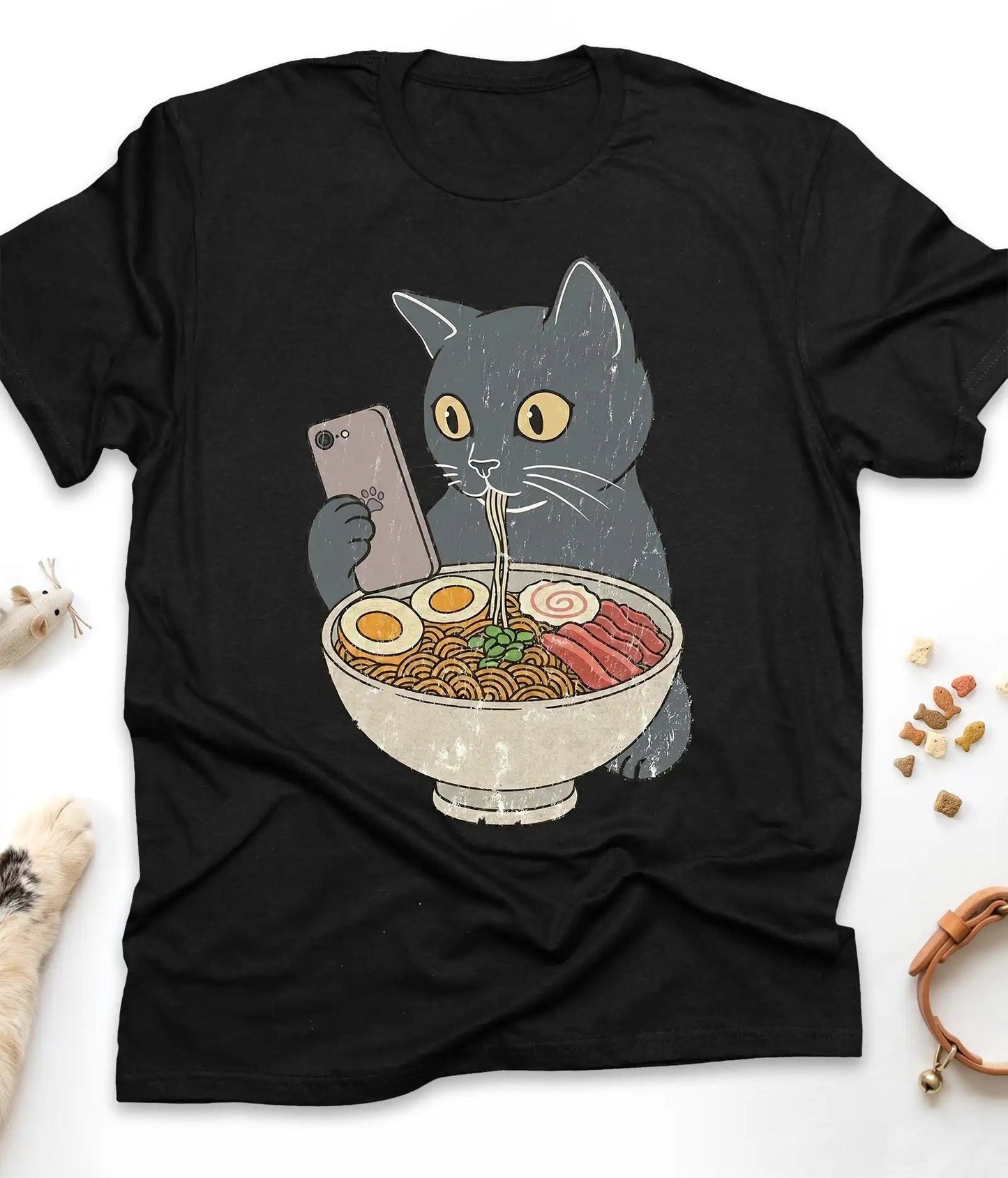Black funny cat t-shirt with a cat slurping ramen noodles, flat lay top view