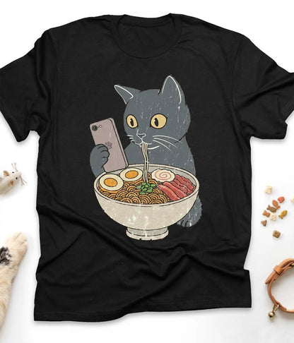 Black funny cat t-shirt with a cat slurping ramen noodles, flat lay top view