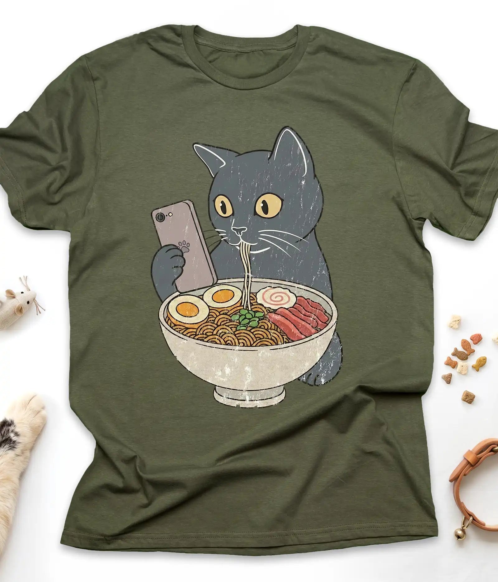 Military Green funny cat t-shirt with a cat slurping ramen noodles, flat lay top view