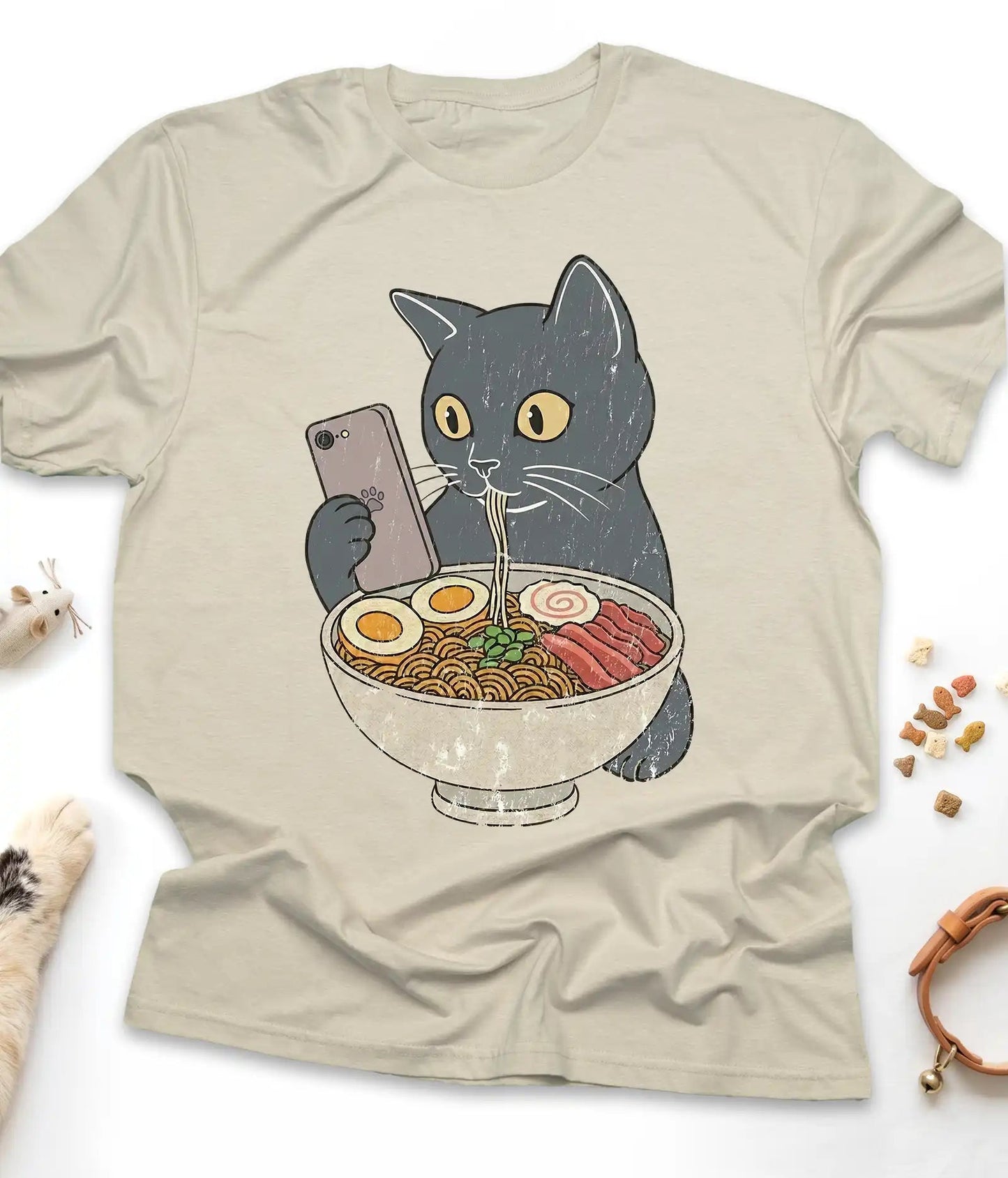 Sand funny cat t-shirt with a cat slurping ramen noodles, flat lay top view