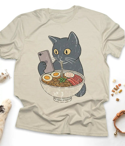 Sand funny cat t-shirt with a cat slurping ramen noodles, flat lay top view