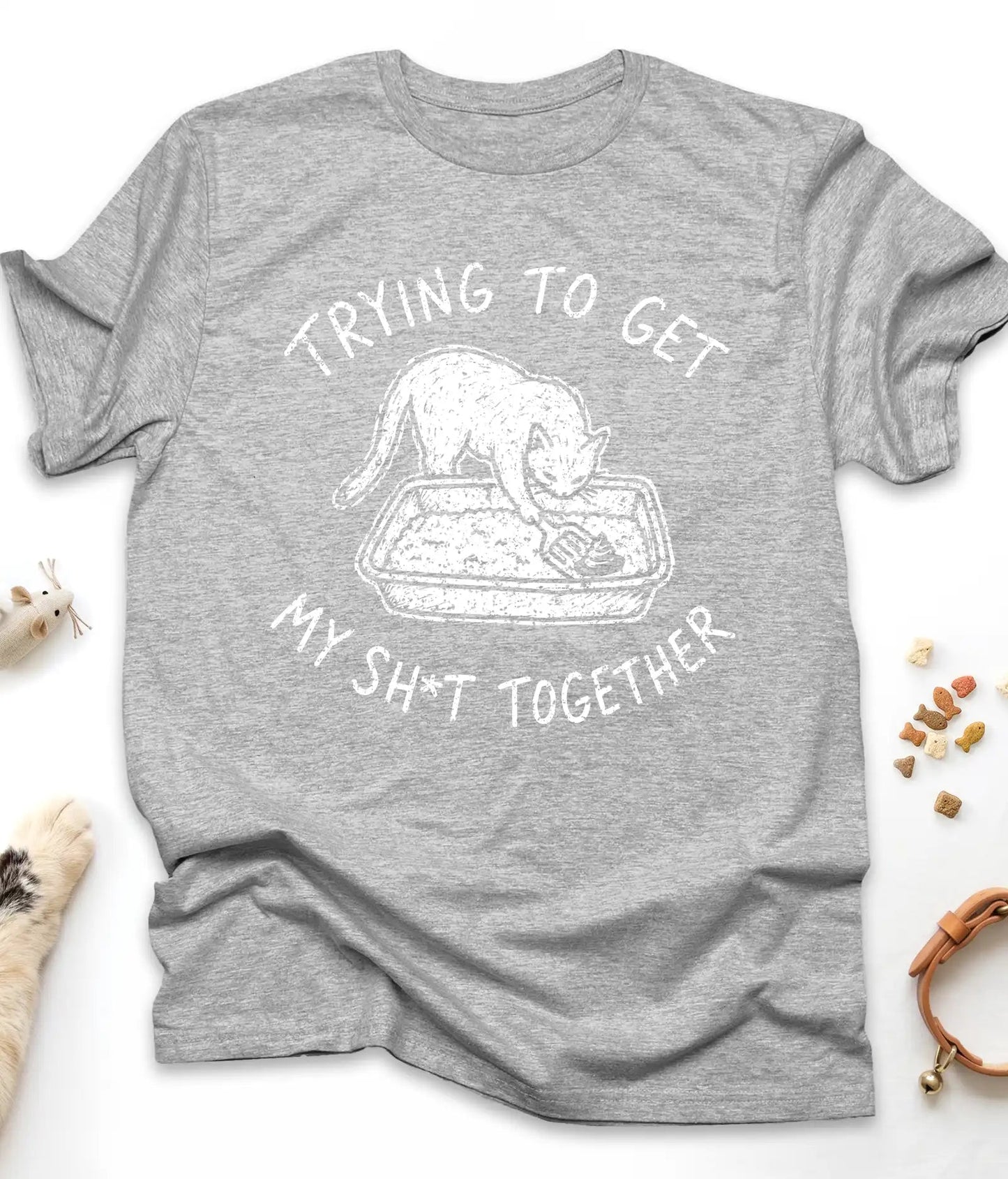 Sport Grey funny cat t-shirt with "Trying To Get My Shit Together" litter box design, flat lay top view