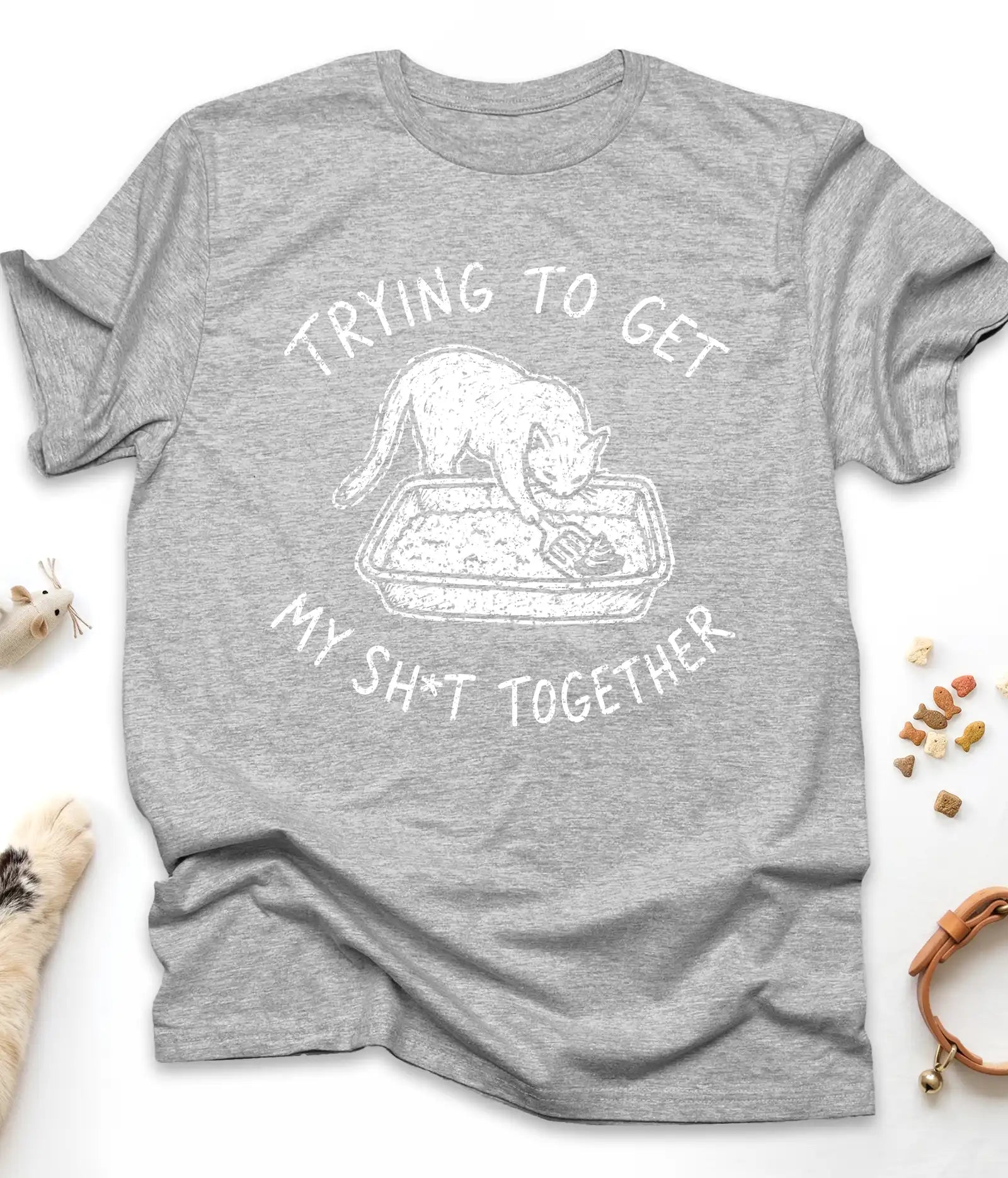 Sport Grey funny cat t-shirt with "Trying To Get My Shit Together" litter box design, flat lay top view