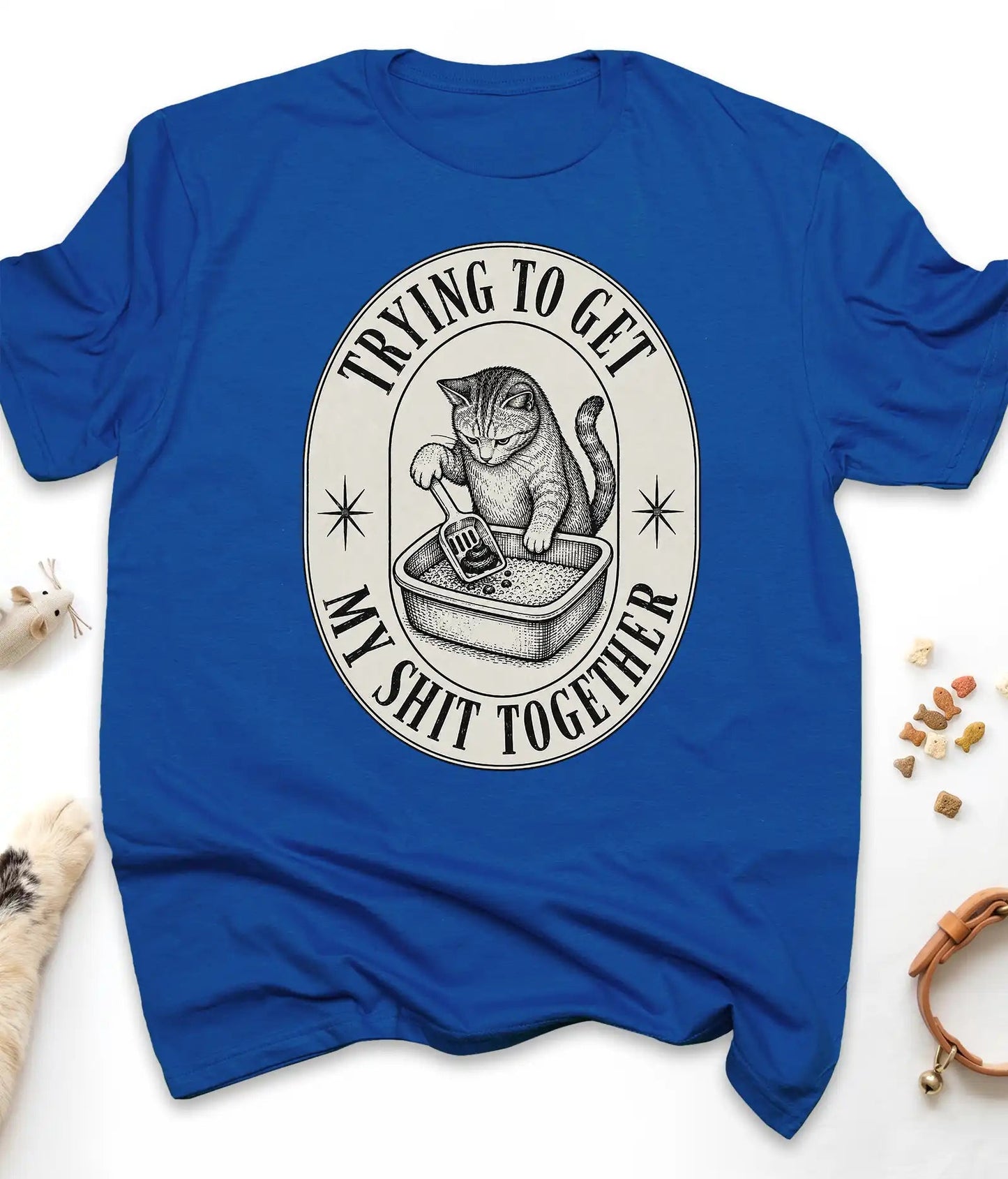 Royal funny cat t-shirt with a vintage "Trying To Get My Shit Together" litter box design, flat lay top view
