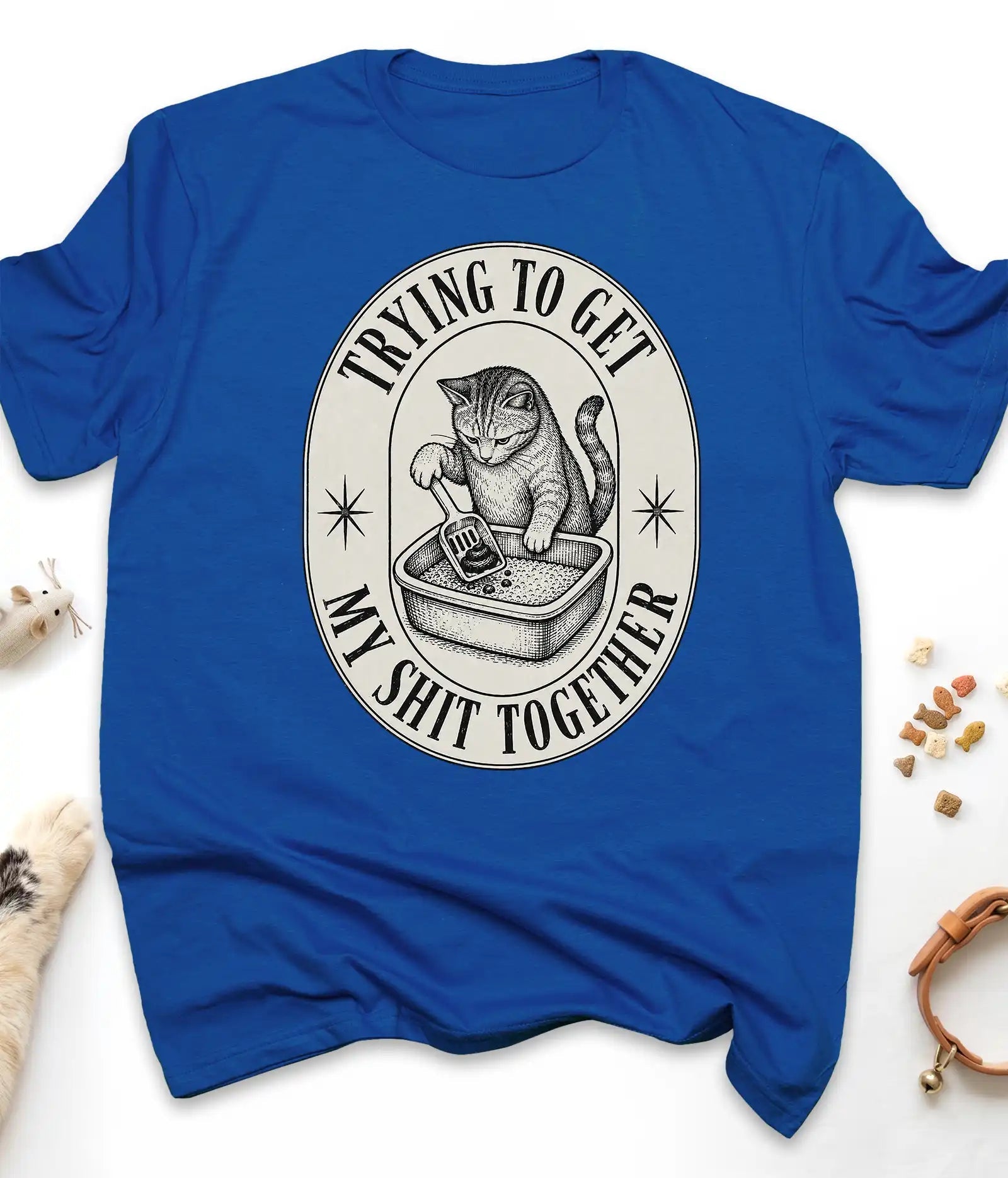 Royal funny cat t-shirt with a vintage "Trying To Get My Shit Together" litter box design, flat lay top view