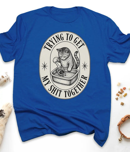 Royal funny cat t-shirt with a vintage "Trying To Get My Shit Together" litter box design, flat lay top view
