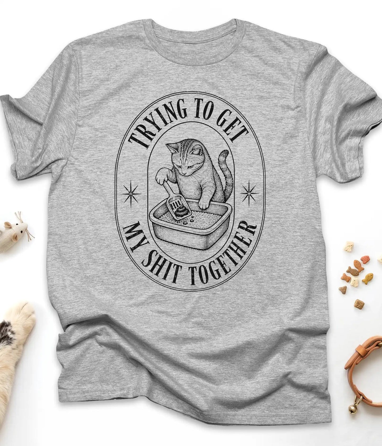 Sport Grey funny cat t-shirt with a vintage "Trying To Get My Shit Together" litter box design, flat lay top view