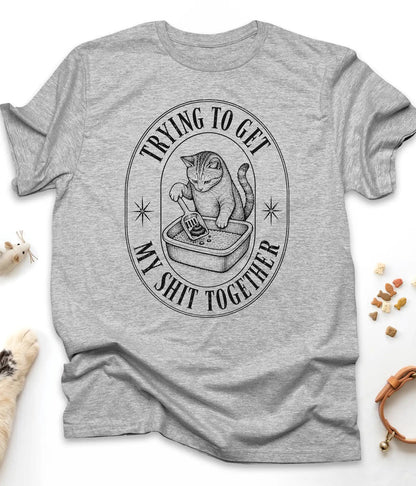 Sport Grey funny cat t-shirt with a vintage "Trying To Get My Shit Together" litter box design, flat lay top view